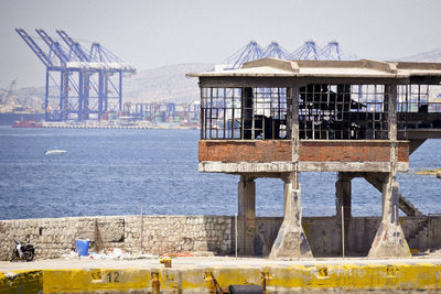 Built structure by sea against clear sky