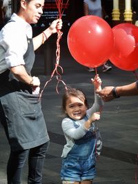 Happy girl holding balloons