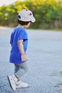 Full length of young woman standing on road