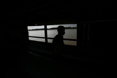 Silhouette of man standing in room