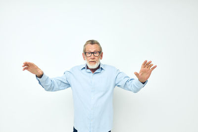 Portrait of man standing against white background