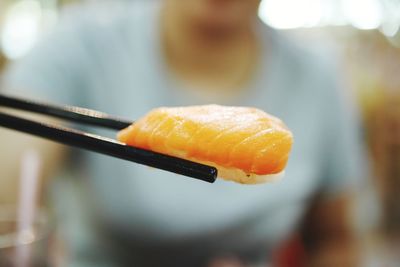 Midsection of man holding fish