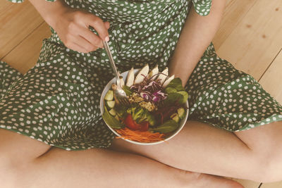 Midsection of woman holding ice cream