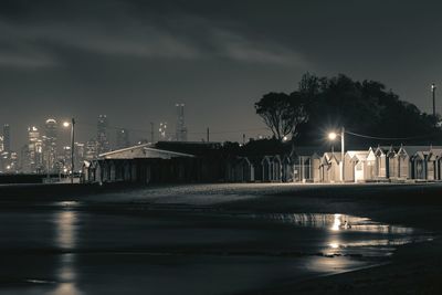 Illuminated buildings against sky at night