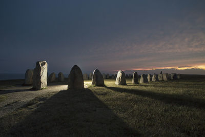 Callanish stone circle on field during sunset