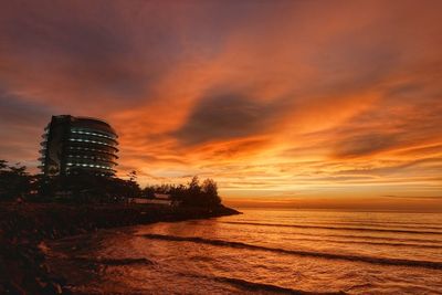 Miri city council on a coast against a fiery sunset afterglow