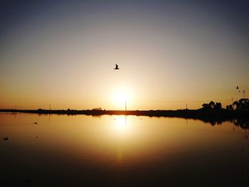 Scenic view of lake against sky during sunset