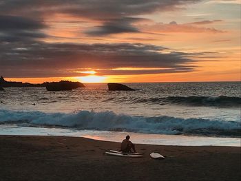 Scenic view of beach against sky during sunset