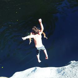 High angle view of boy diving in lake