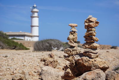 Stack of rocks on land against sky