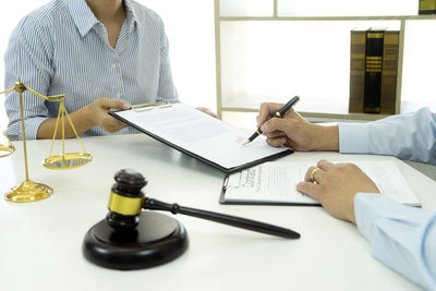 Midsection of man working on table