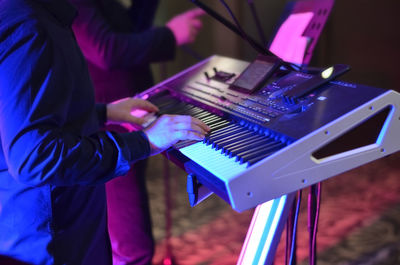 Side view of man playing piano