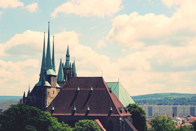 Buildings against cloudy sky