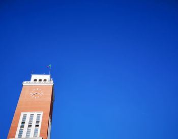 Low angle view of city hall against clear blue sky