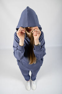 Full length portrait of young sporty fitness women in blue cotton hooded sweatsuit casual outfit