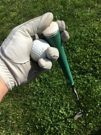 High angle view of person holding umbrella on grass