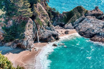 High angle view of rocks on sea shore