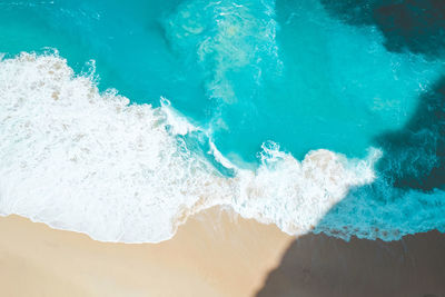 High angle view of waves splashing on sea