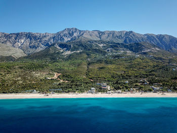 Scenic view of the beach against clear blue sky