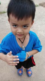 Cute boy holding blue outdoors