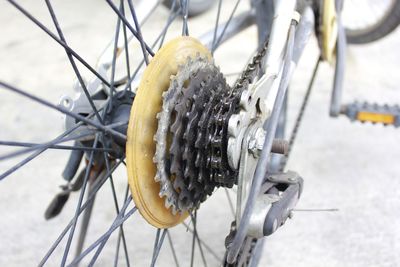 Close-up of bicycle wheel by sea