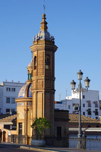 View of buildings against clear blue sky