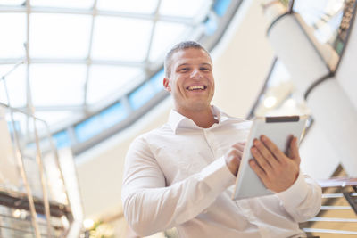 Portrait of smiling young man using mobile phone
