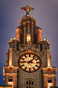 Low angle view of illuminated buildings against sky liverpool