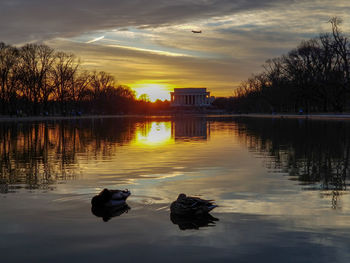 Scenic view of lake against sky during sunset