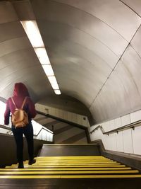 Full length of woman standing at subway station