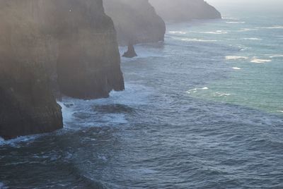 Scenic view of sea by cliff