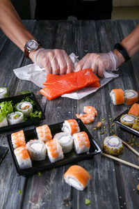 Man holding fish on barbecue grill
