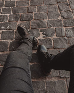Low section of man standing on tiled floor