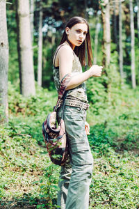 Side view of a young woman standing on field