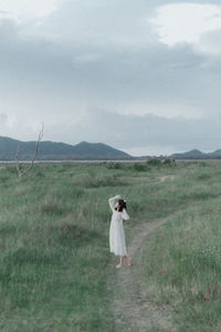 Full length of man standing on field against sky