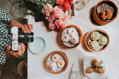 High angle view of hand holding food on table