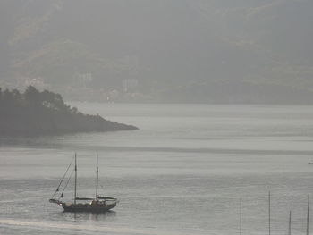 Sailboat on sea against sky