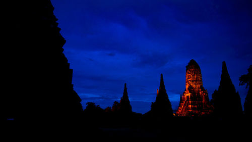 Silhouette of temple against sky at dusk