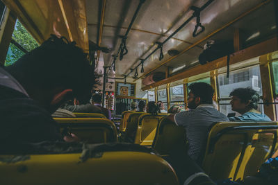 Rear view of people sitting in bus