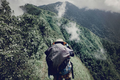 Rear view of man looking at mountains