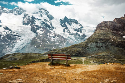 Bench among snow mountains. zermatt, swiss alps. place for loneliness and relax in switzerland