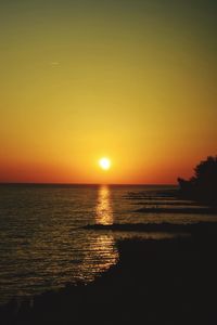 Scenic view of sea against romantic sky at sunset