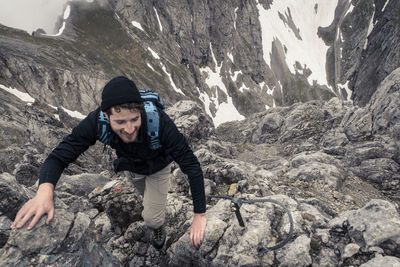 Man climbing rocky mountain