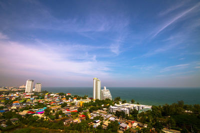 View of buildings in city against cloudy sky