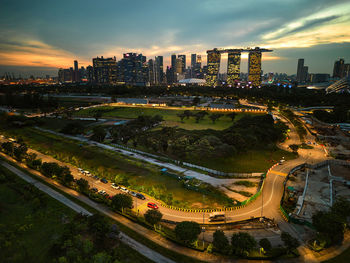 High angle view of illuminated cityscape against sky during sunset