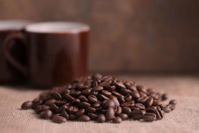 Close-up of roasted coffee beans on fabric