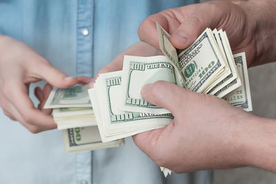 Midsection of man holding paper