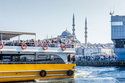 View of boats in city against clear sky