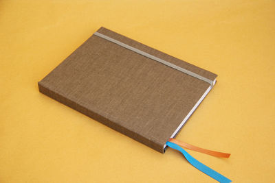 High angle view of pen on table against yellow background