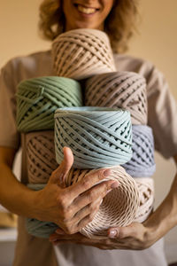 Midsection of woman holding ribbons